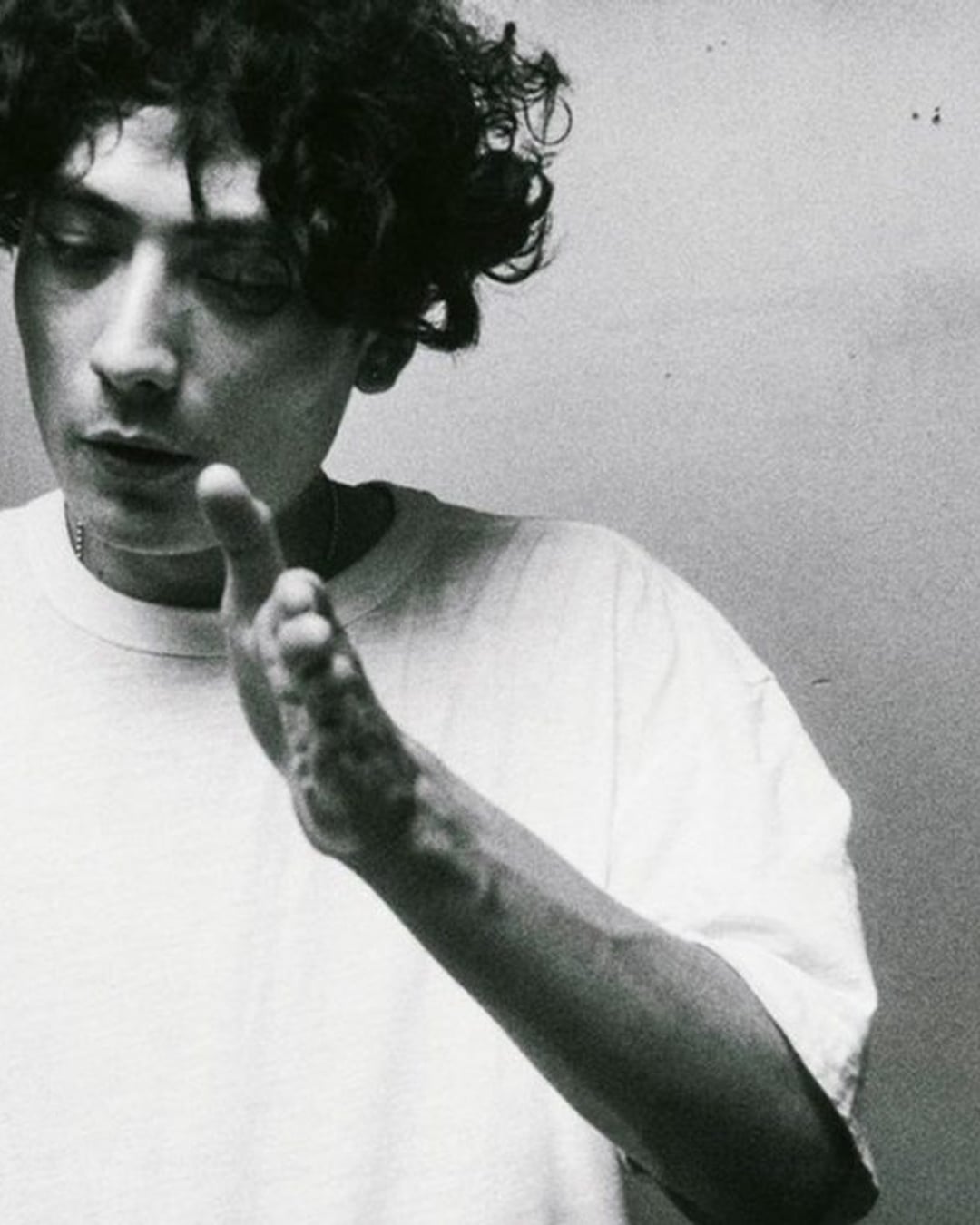 Interplanetary Criminal, calm and focused in a white T-shirt, the producer behind B.O.T.A.