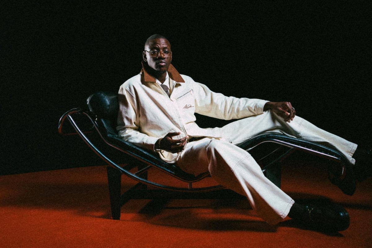 KILIMANJARO, the Zambian-heritage afro house DJ and producer, reclining in a cream suit