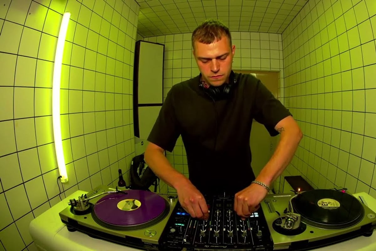 Main Phase, the Copenhagen speed garage producer, DJing in a green-tiled booth