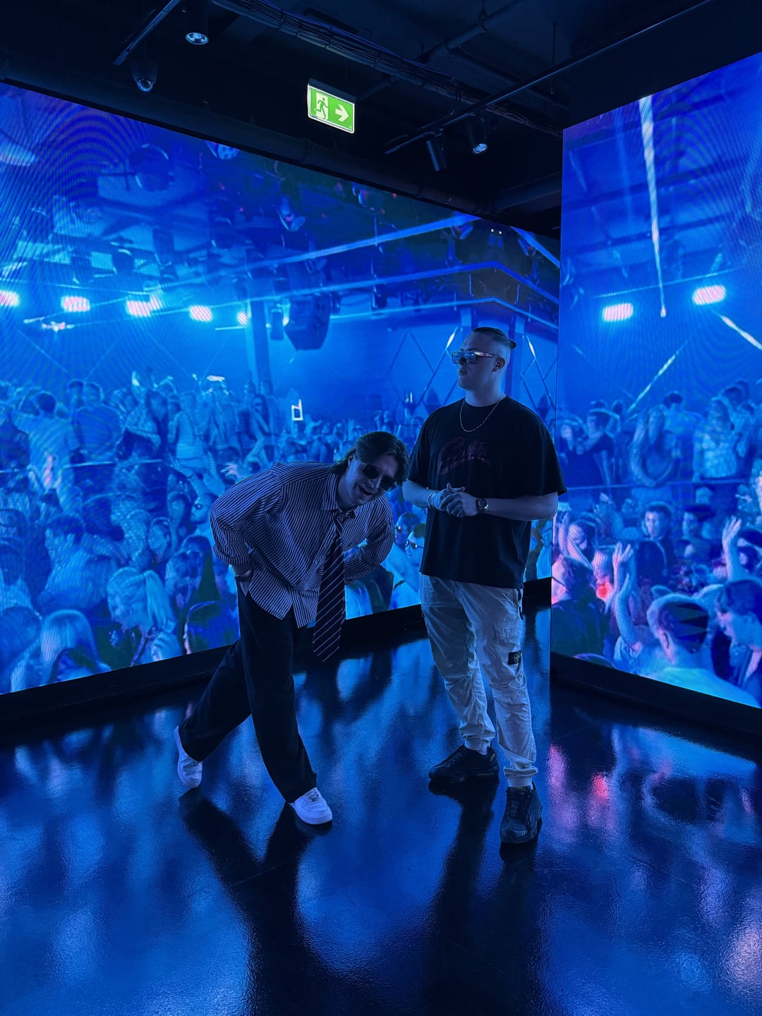 MNEEMO and CABBA LAGA above a packed dancefloor washed in blue light.