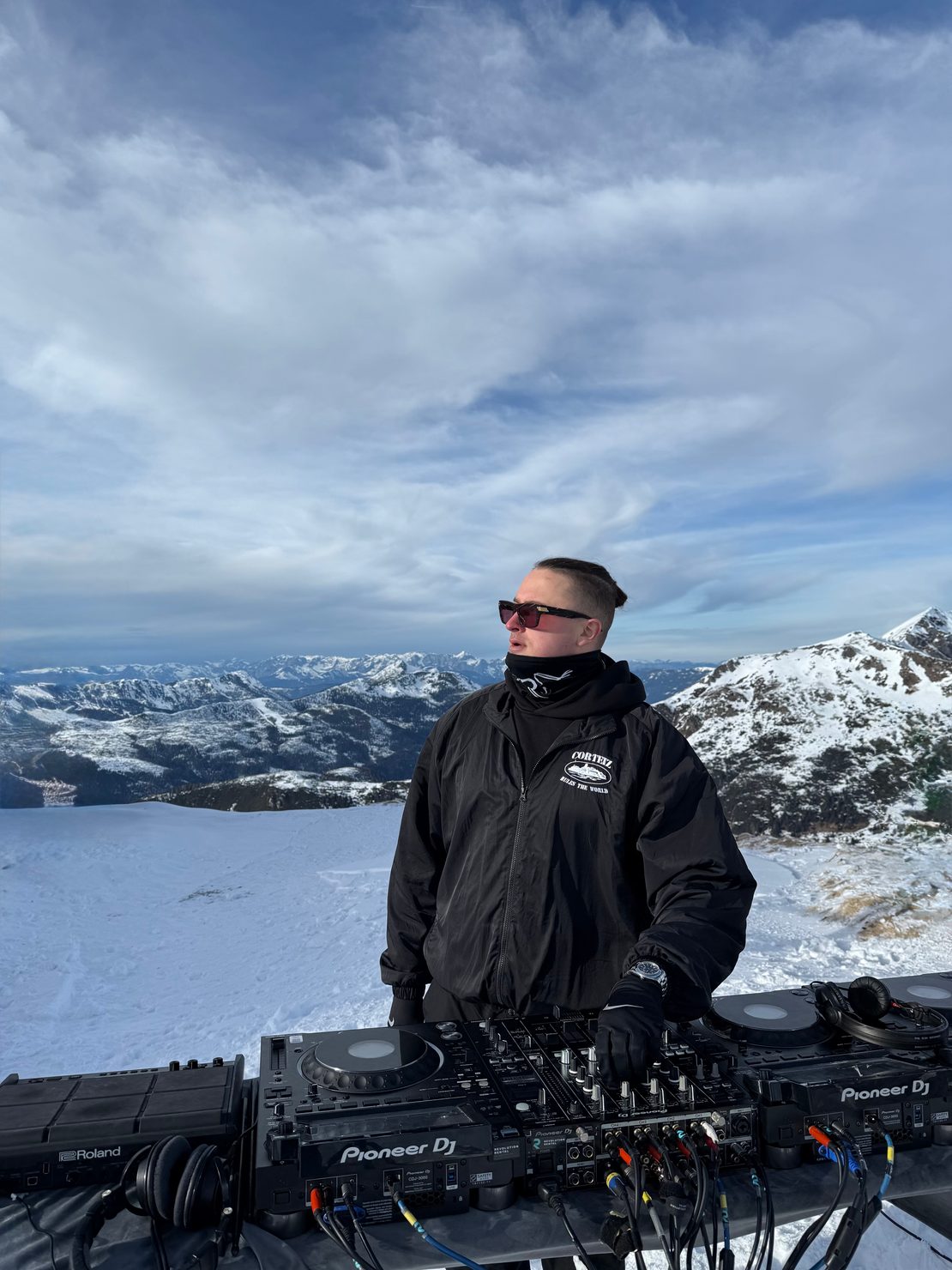 MNEEMO (Yaroslav Gorovoy) standing by the DJ setup on Austrian Mountain during recording of his DJ set in Austrian Alps.